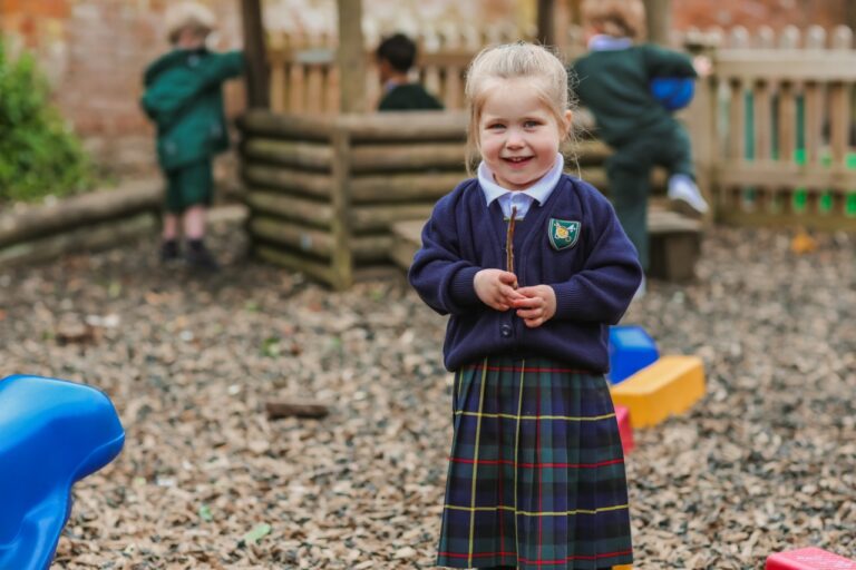 A child playing with sticks at St Peter’s Prep