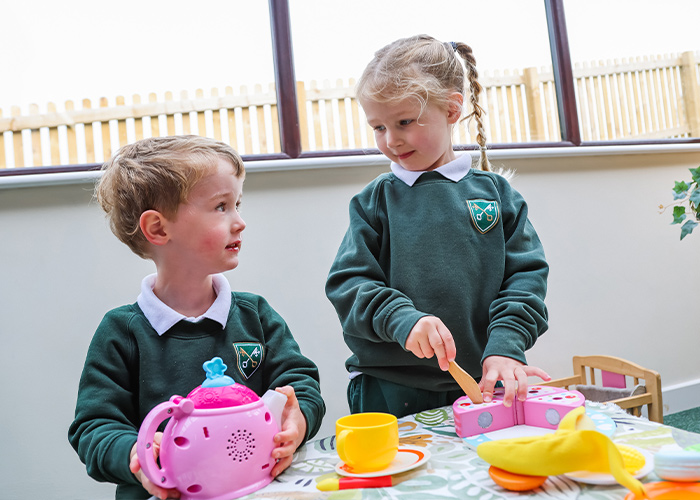 Two nursery pupils enjoying their day