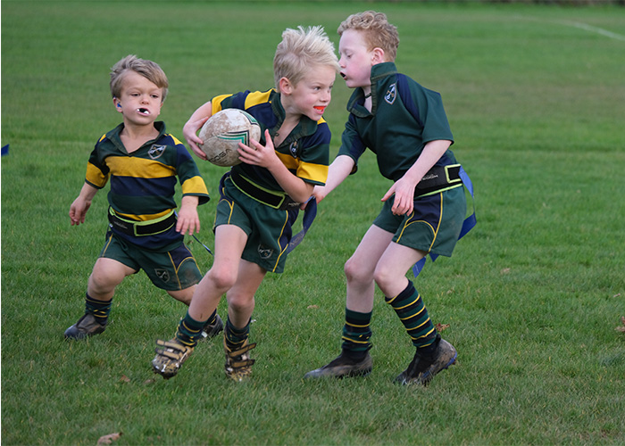 Some young boys enjoying a rugby game