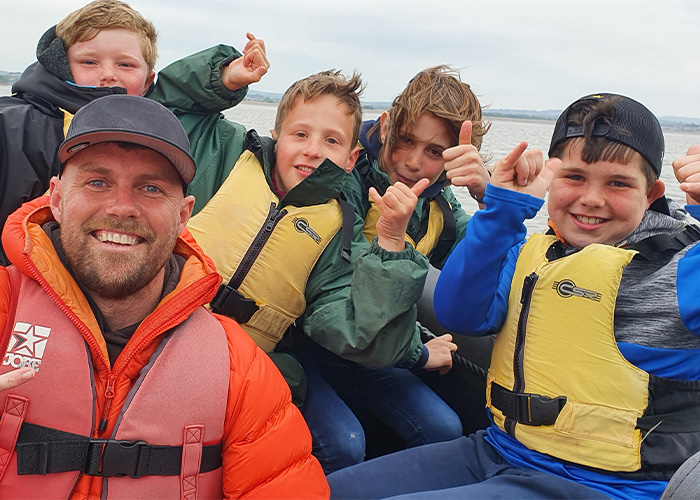 Happy students enjoying a boat trip