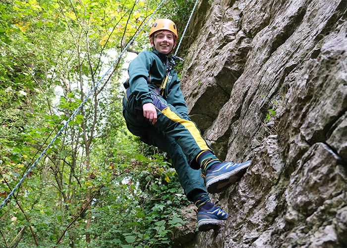 Successful student enjoying a climb on an activity day
