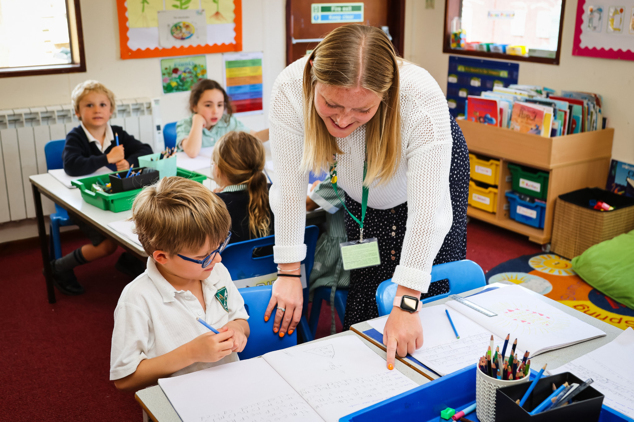 A teacher helping a student in class