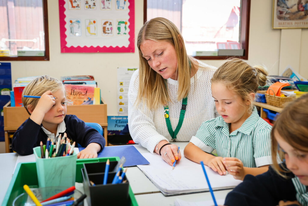 A teacher with pupils at St Peter’s Prep learning to write