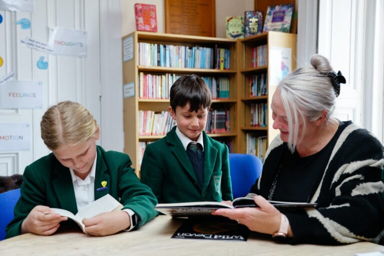 A teacher and pupils reading at St Peter’s Prep
