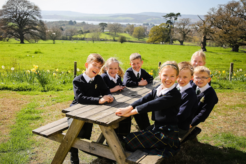 St Peter's Prep students outside on benches and smiling