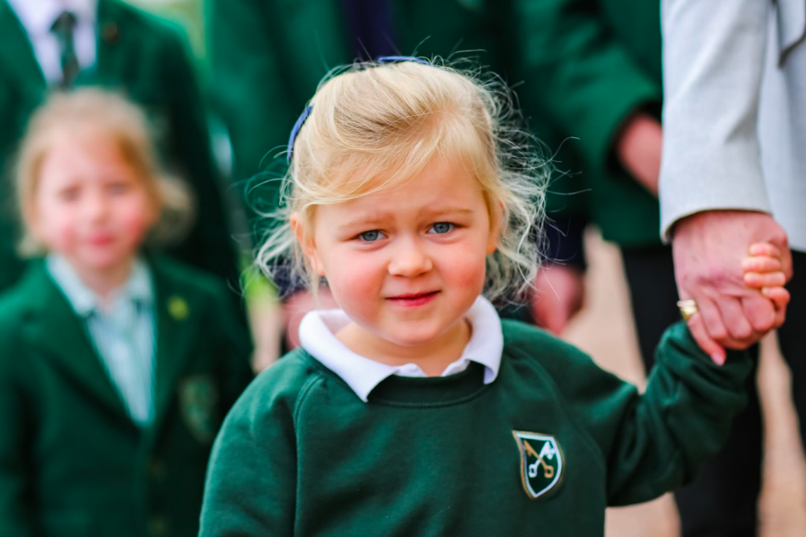 A student holding a teachers hand