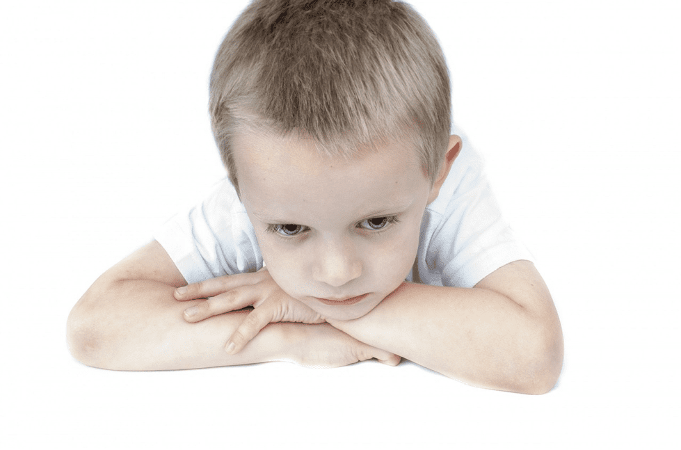 A picture of a boy with his arms crossed