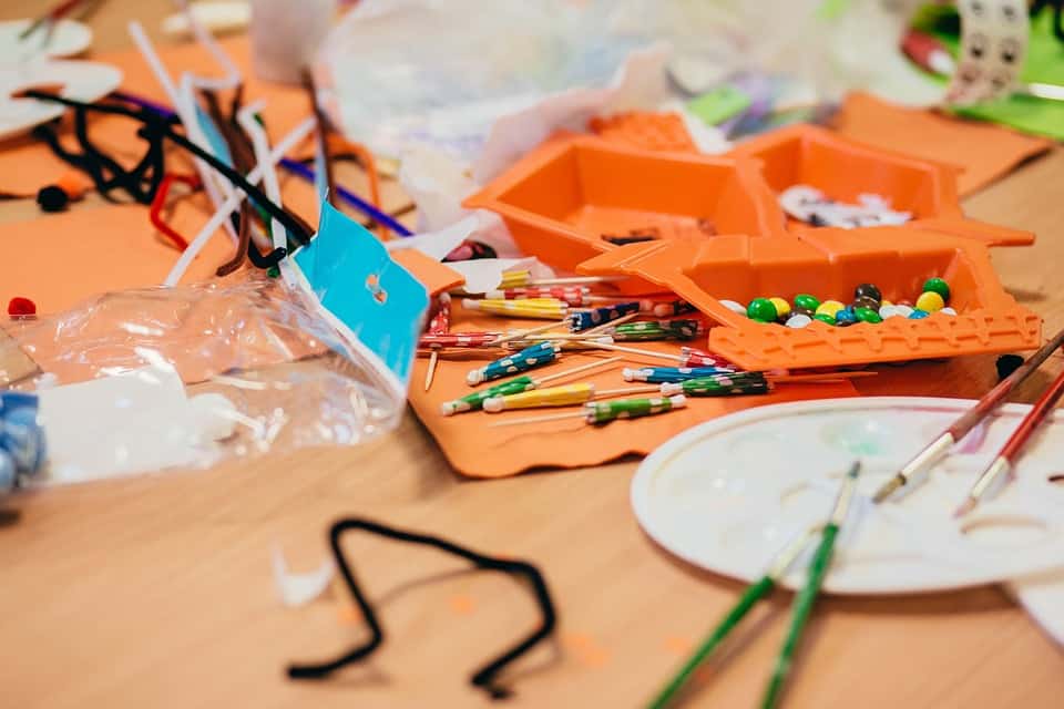 Used crafting materials for children spread out across a table