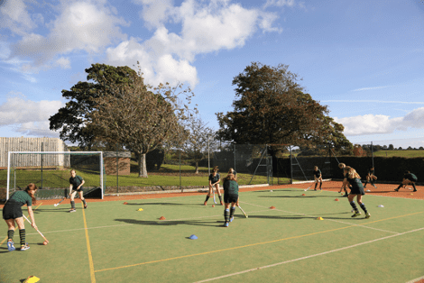 Young children playing field hockey at St Peter's Prep School
