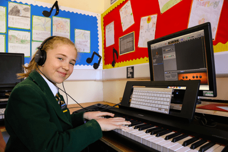 A young girl learning the piano at St Peter's Prep School