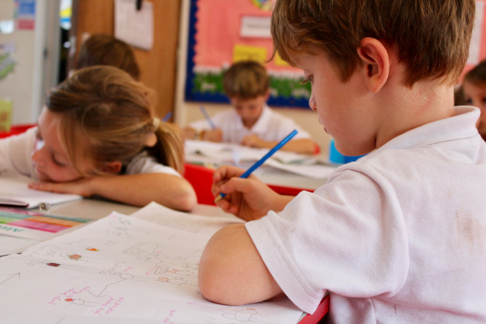 A class of St Peter’s pupils writing in their books