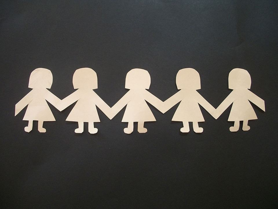 Paper cutout dolls holding hands