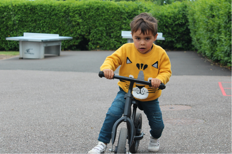 A child riding a balance bike
