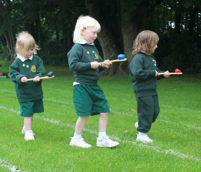 Young children taking part in an egg and spoon race