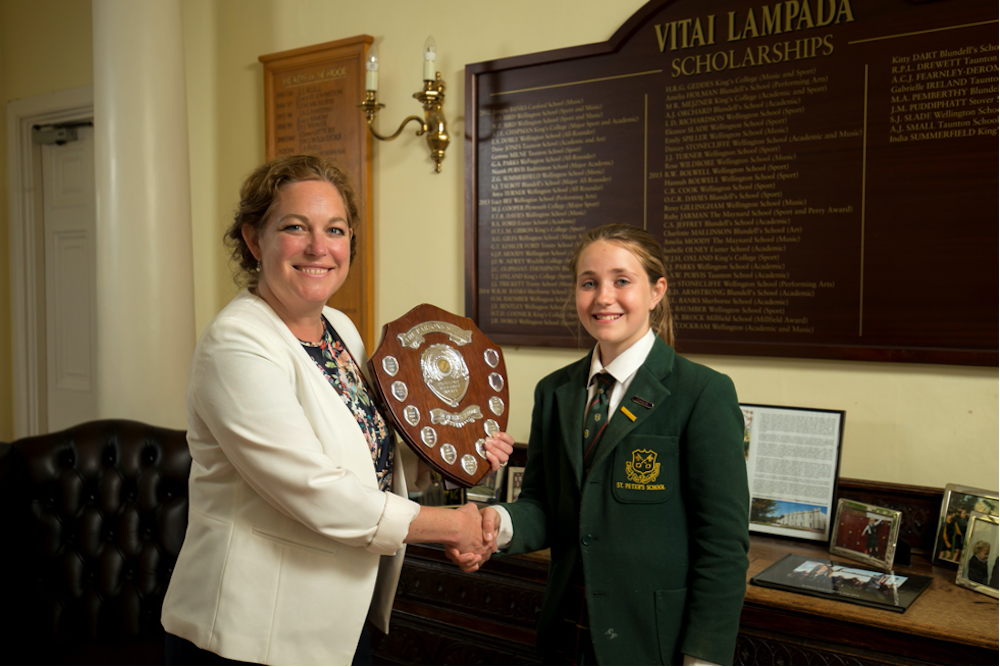 The Head presenting a shield to a pupil