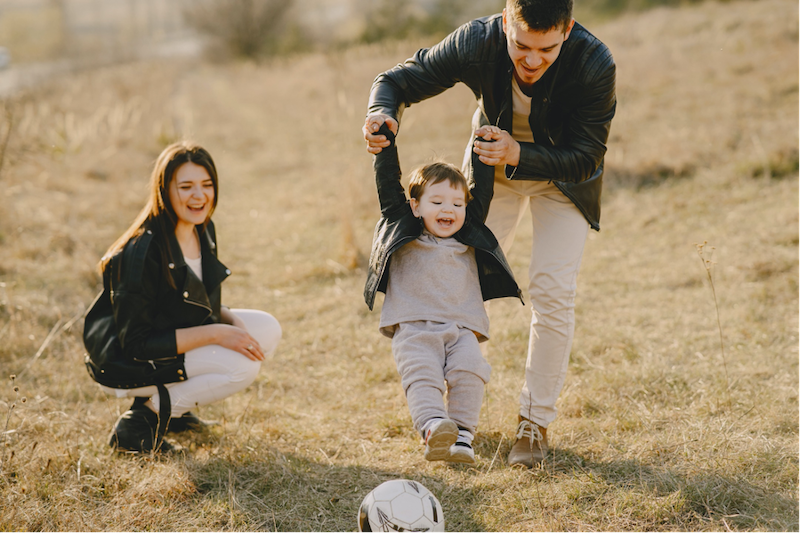 A family walking with their dog