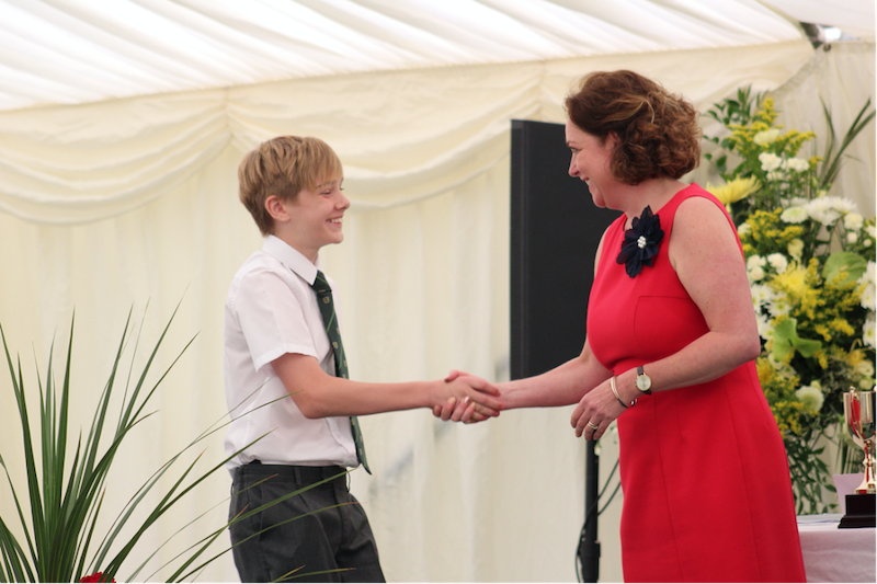 Head teacher presenting student with an award