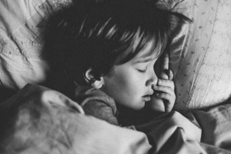 A young child sleeping soundly in bed