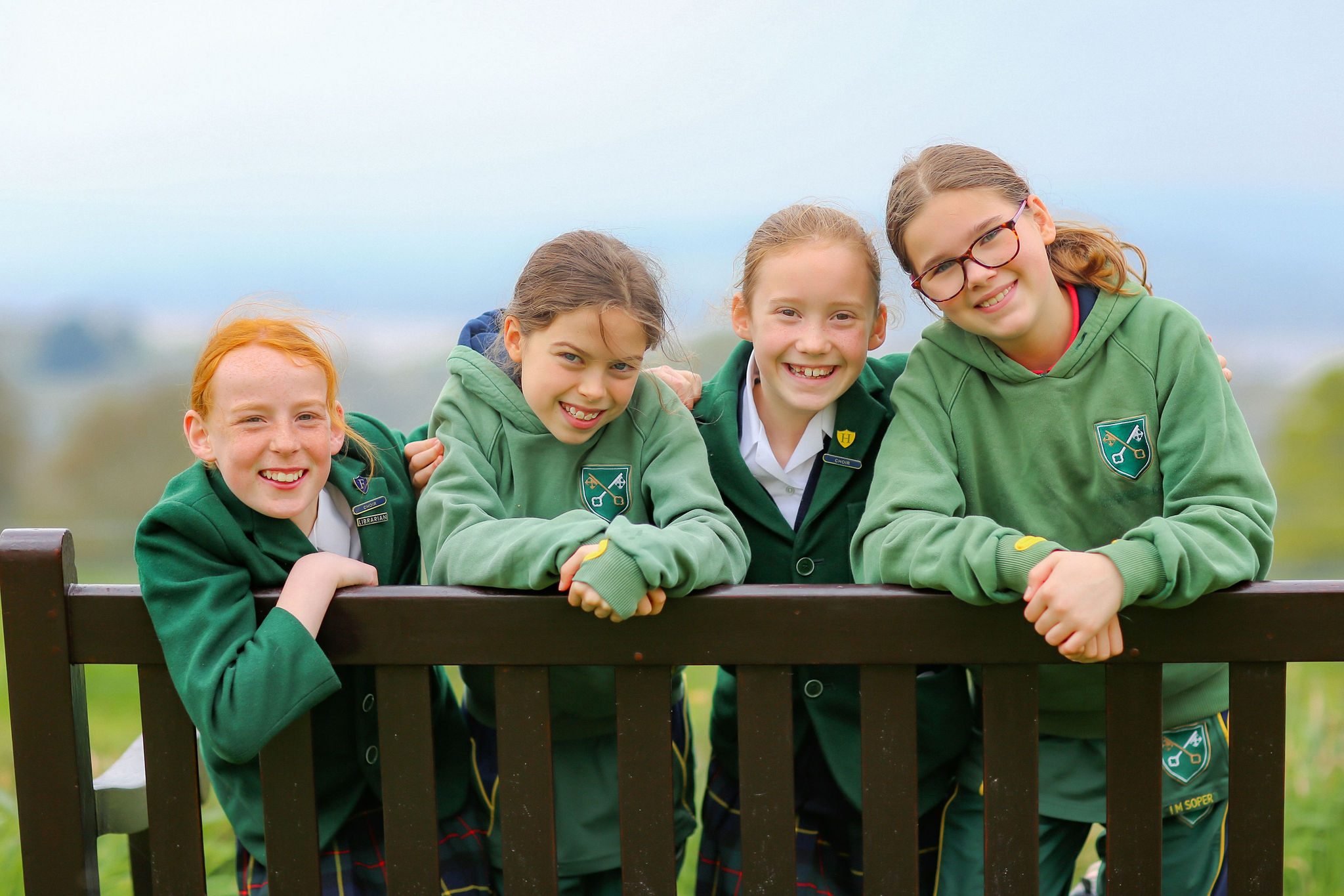 A group of St Peter’s pupils sitting by a bench