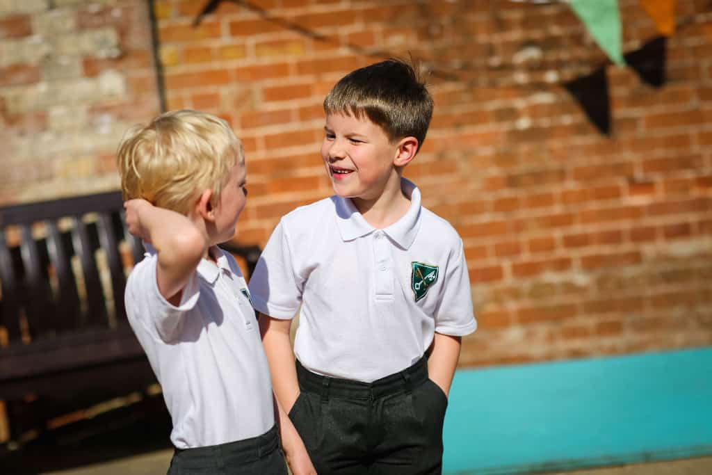 two boys in the playground laughing