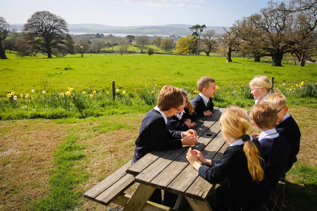 children sitting on a bench outside
