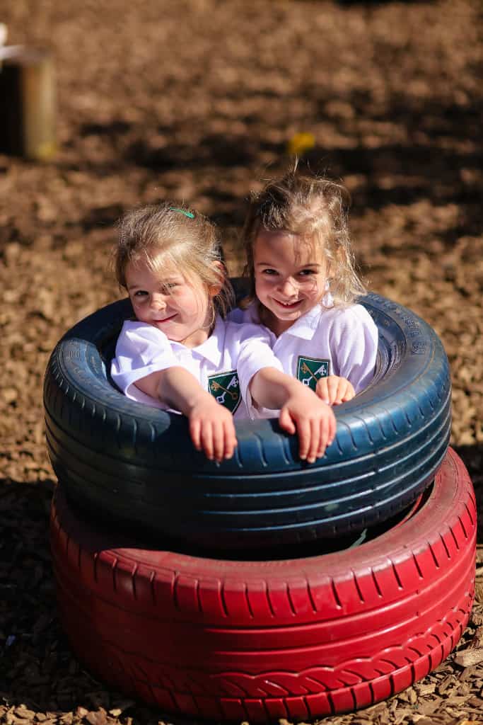 Two children sat in tires