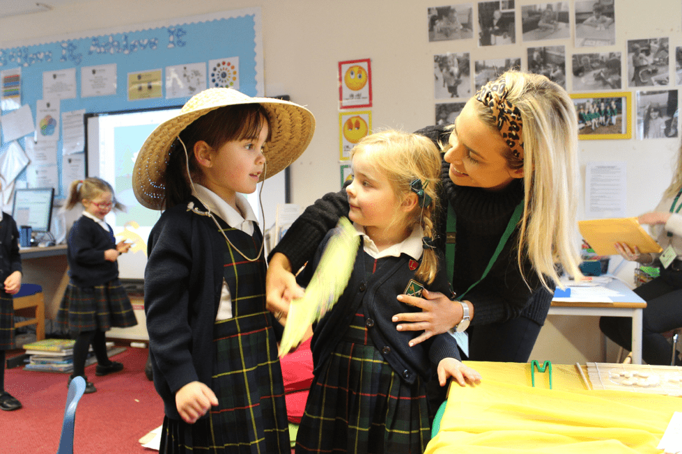 A teacher helping the girls get ready for China day.