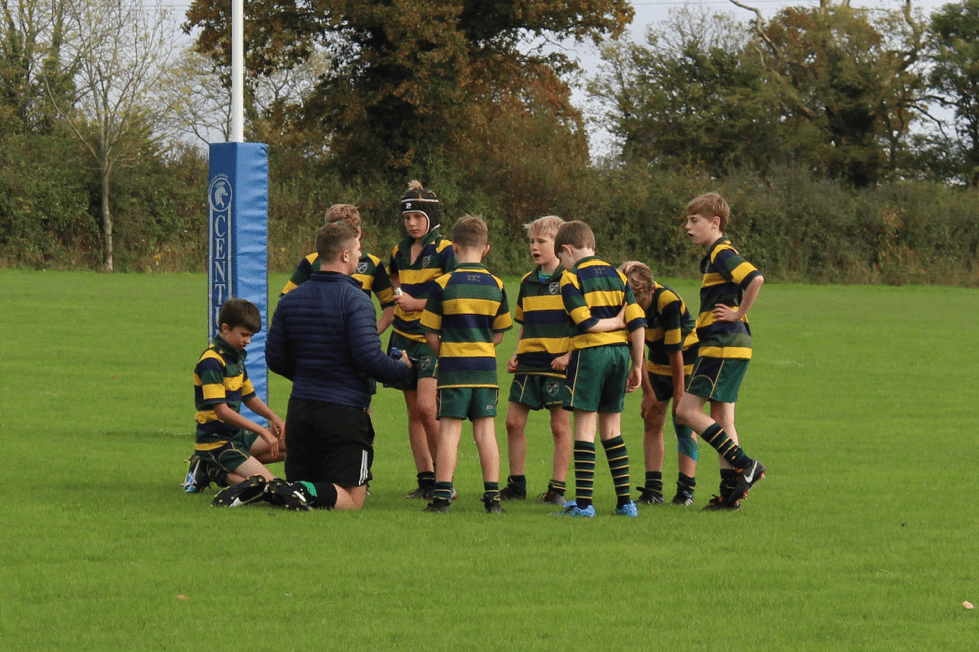 A coach reassures and motivates a rugby team