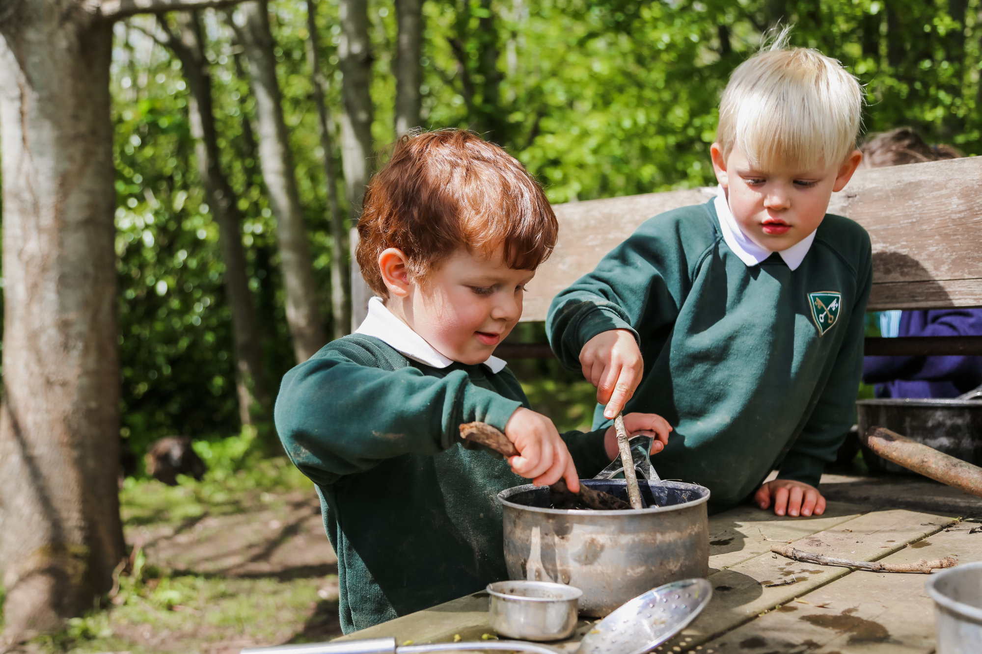 Two children helping in a cooking class