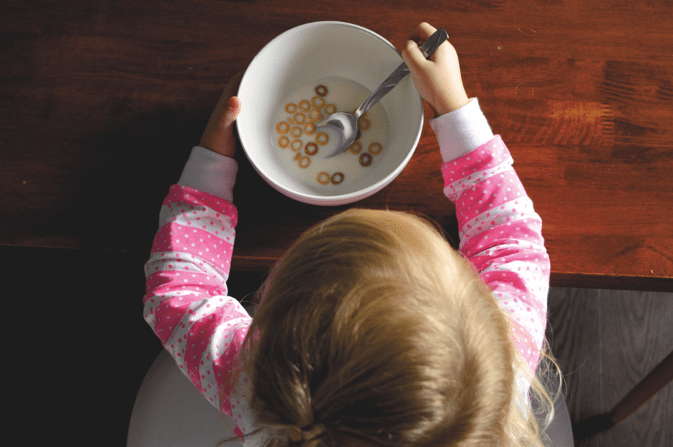 A girl eating a bowl of cereal.