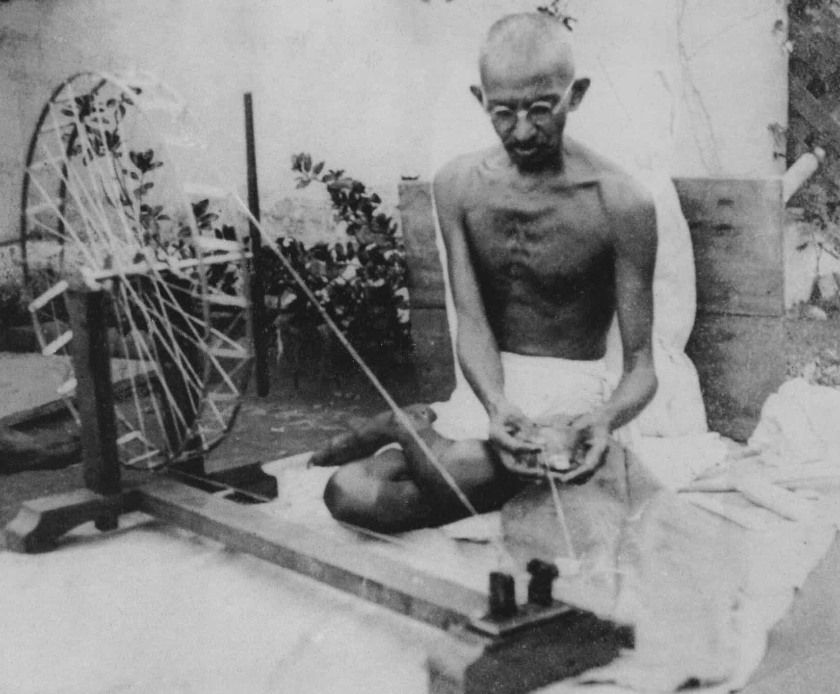Photograph of Mahatma Gandhi spinning thread with charkha