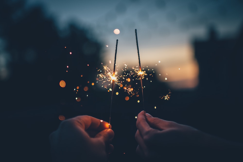 Two adults holding sparklers