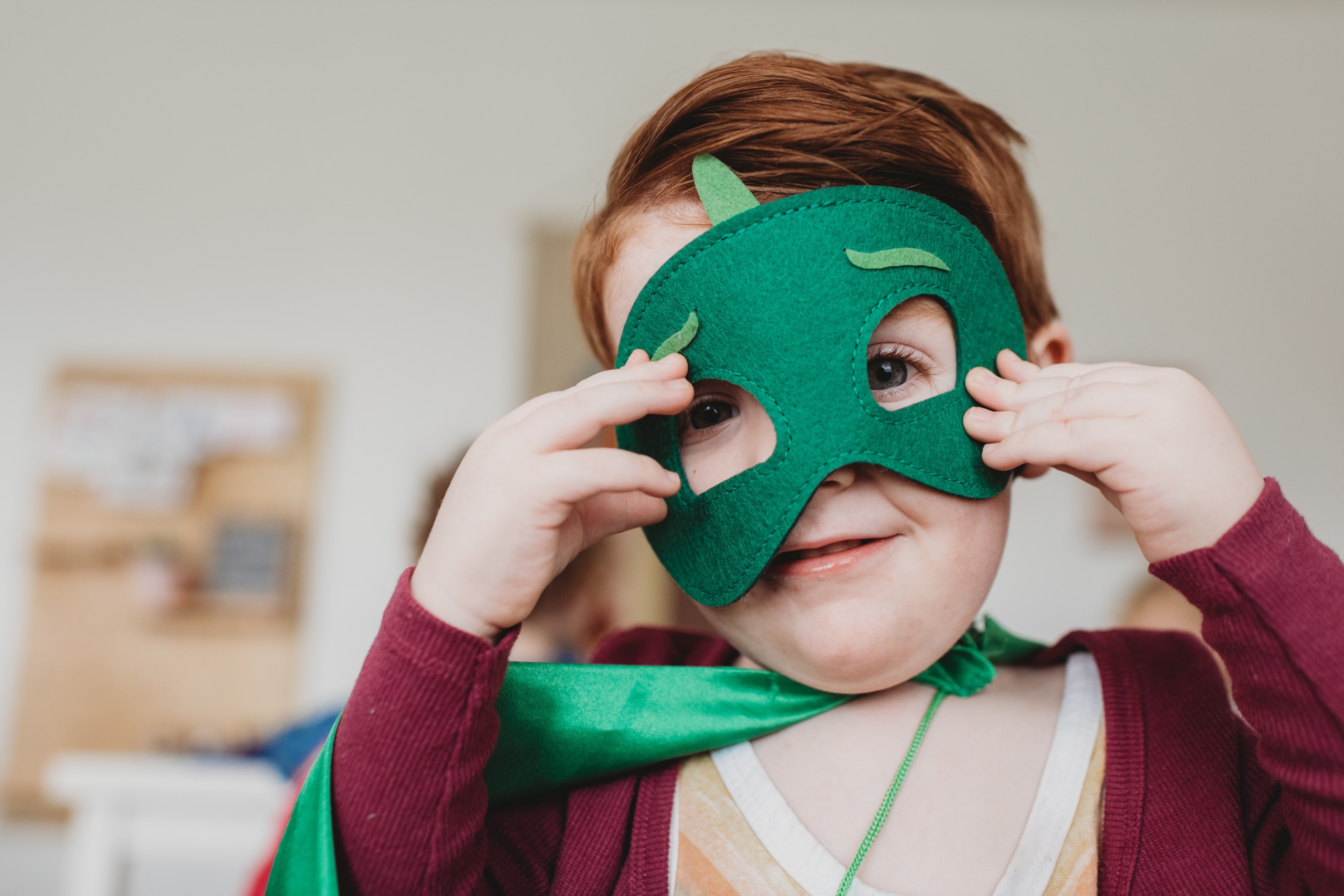 A child wearing a costume mask