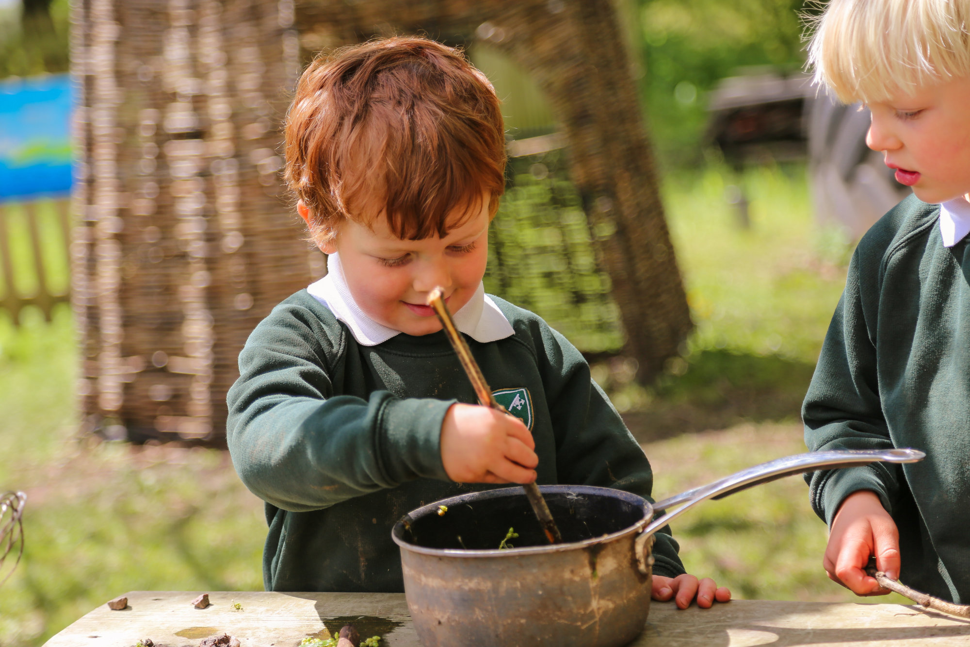 two children in an outdoor cooking class