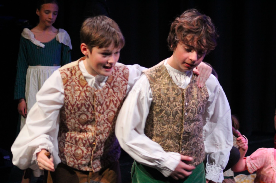 two students acting in a performing arts show