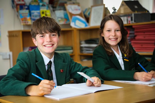 A boy and girl writing