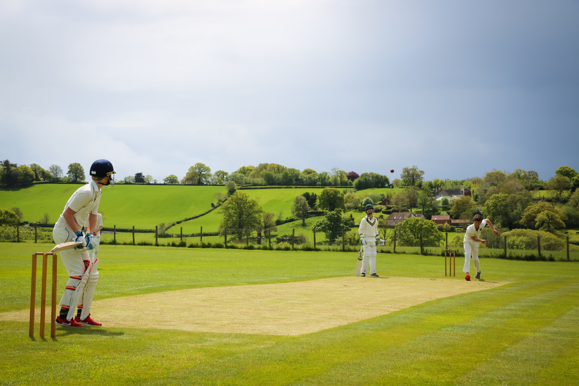 Students playing a game of cricket