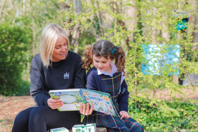 A teacher assistant and pupil at St Peter’s Prep during forest school