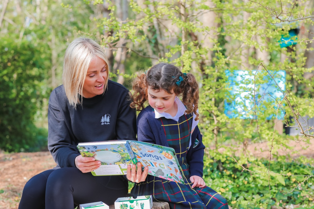 A teacher assistant and pupil at St Peter’s Prep during forest school